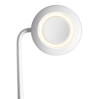 White circular lamp with a smooth surface and warm LED glow, featuring a minimalist design and sleek curved arm.