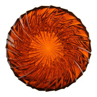 Amber crystal decorative plate with a sunburst pattern and radiant, translucent surface. Perfect for home decor.