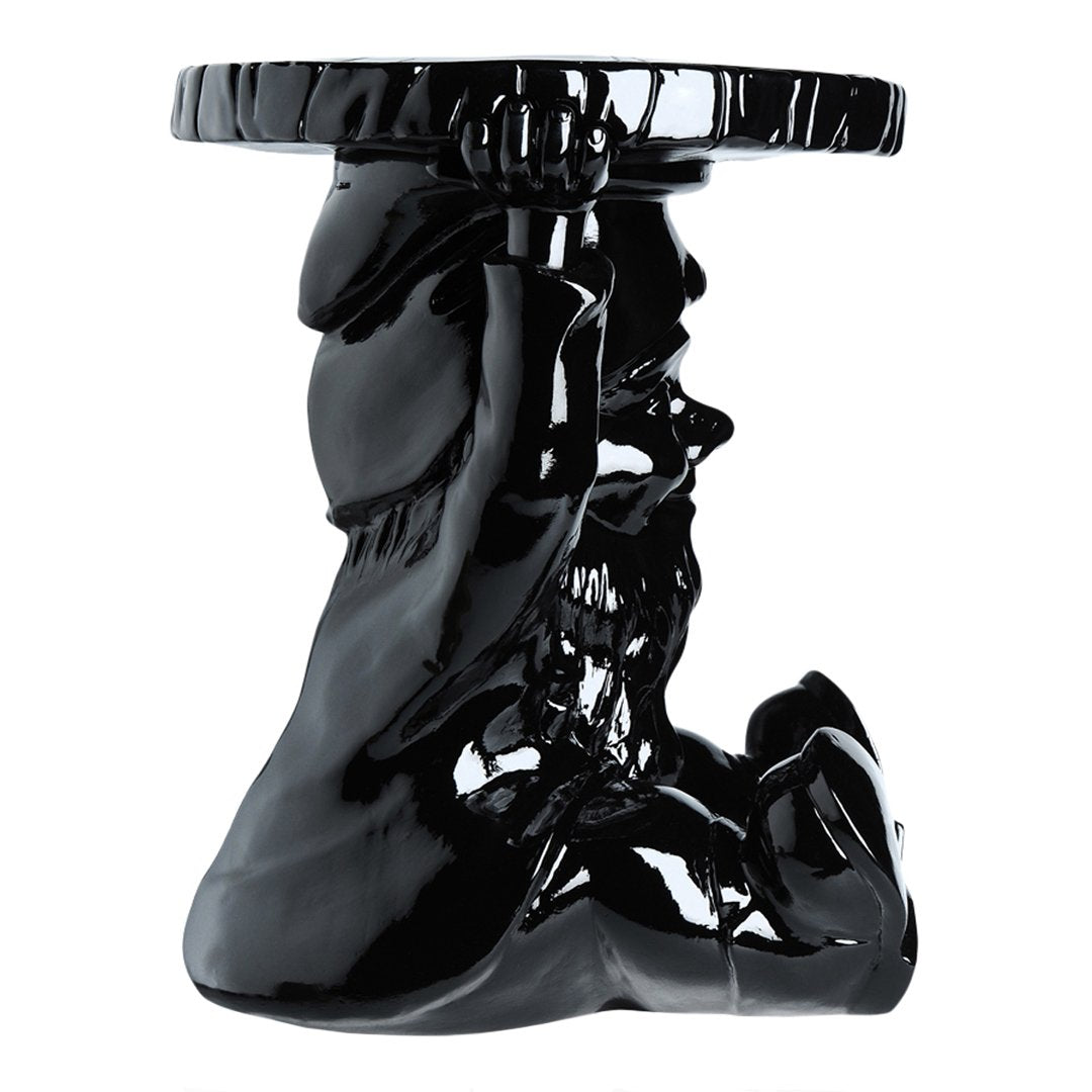 Glossy black accent table featuring a sculptural design with elegant contours and a smooth finish.