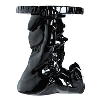 Glossy black accent table featuring a sculptural design with elegant contours and a smooth finish.