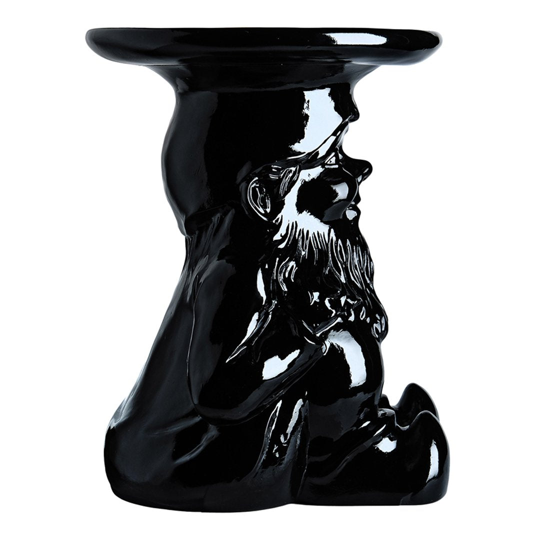 Glossy black ceramic stool featuring a sculpted gnome design, adding a unique decorative touch.
