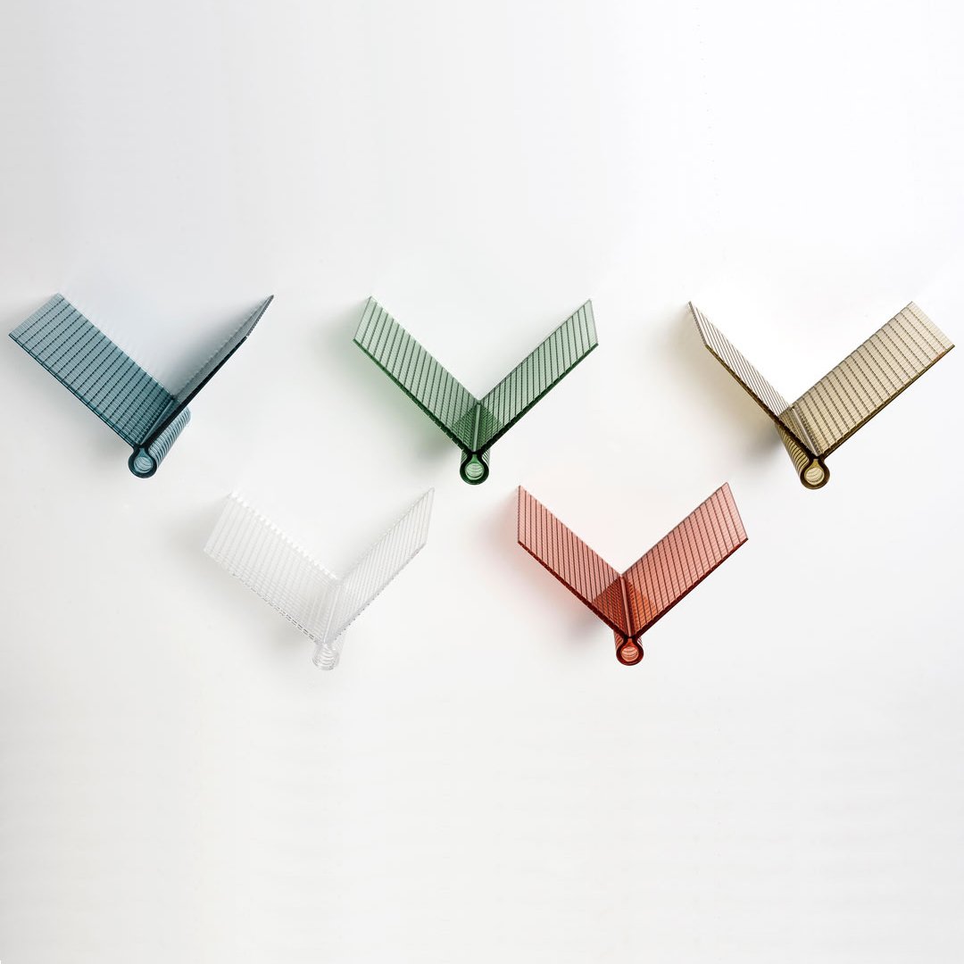 Colorful geometric organizers in blue, green, clear, orange, and white with textured ribbed patterns.