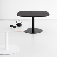 Modern round tables in black and white, showcasing smooth finishes and minimalist design. Perfect for contemporary decor.