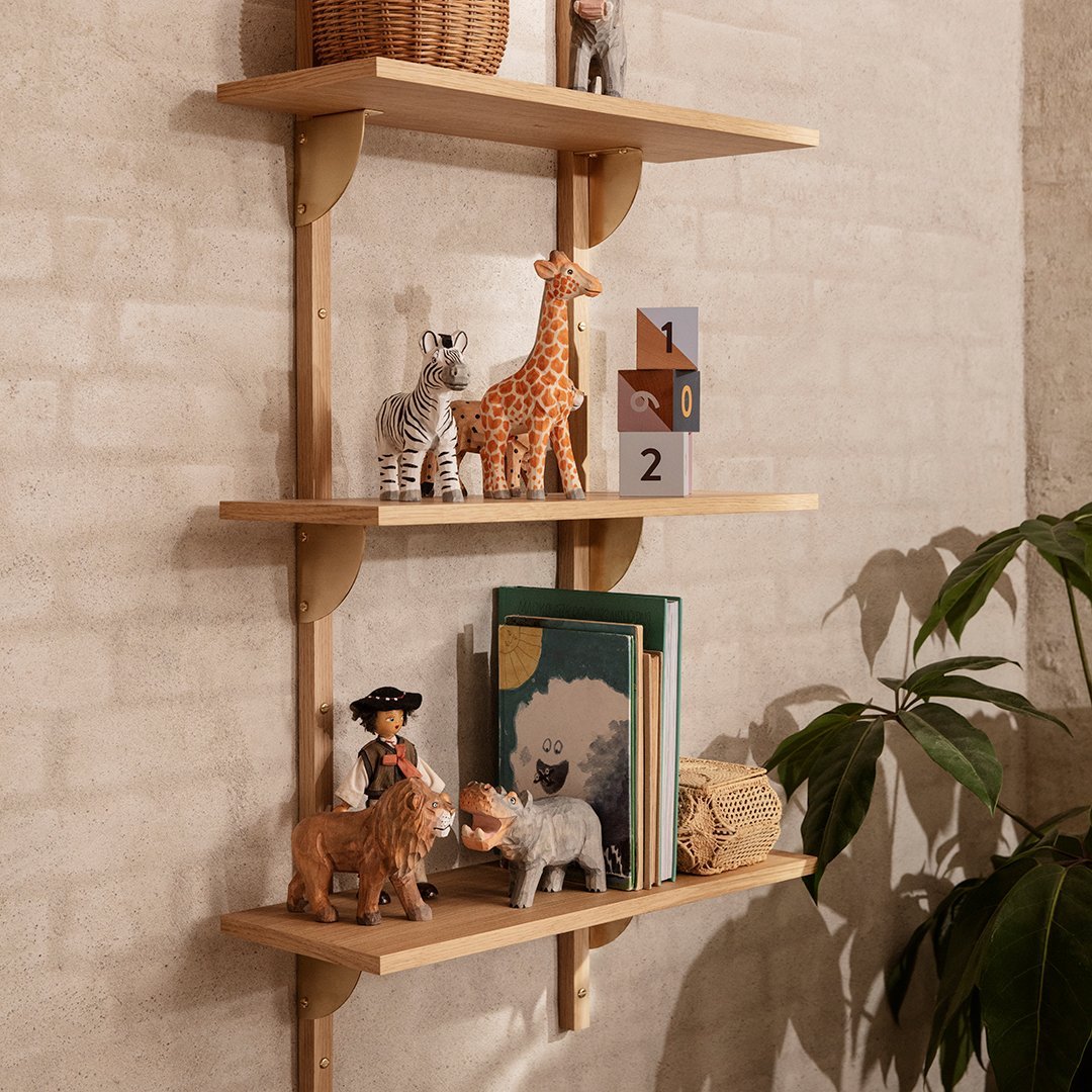 Wooden shelving unit with natural finish, featuring playful animal figurines and colorful books against a textured beige wall.
