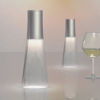 Sleek silver tops with transparent ribbed glass bases, creating a modern and elegant ambiance.