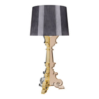 Elegant gold and silver lamp base with a striped black and white lampshade for a striking contrast.