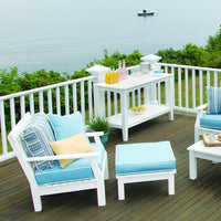 "Blue and white patio furniture with striped and solid cushions, set against a serene outdoor backdrop."