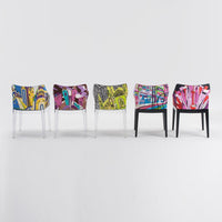 Colorful chairs with vibrant abstract patterns in blue, yellow, green, pink, and black against a neutral background.