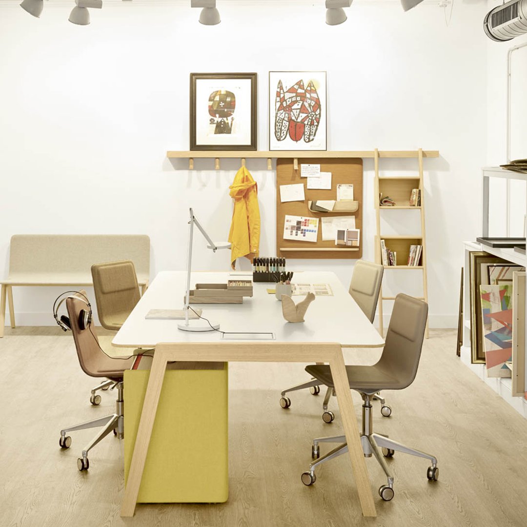 Modern workspace featuring neutral tones, earthy browns, vibrant yellow, and geometric patterns on decor.