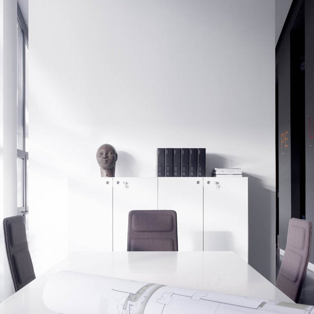 Modern office space featuring a sleek white color scheme and elegant gray accents, with minimalist design elements.