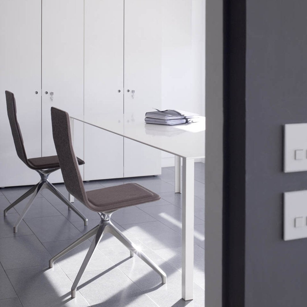 Modern gray and white workspace featuring sleek brown chairs with minimalist design and soft textures.