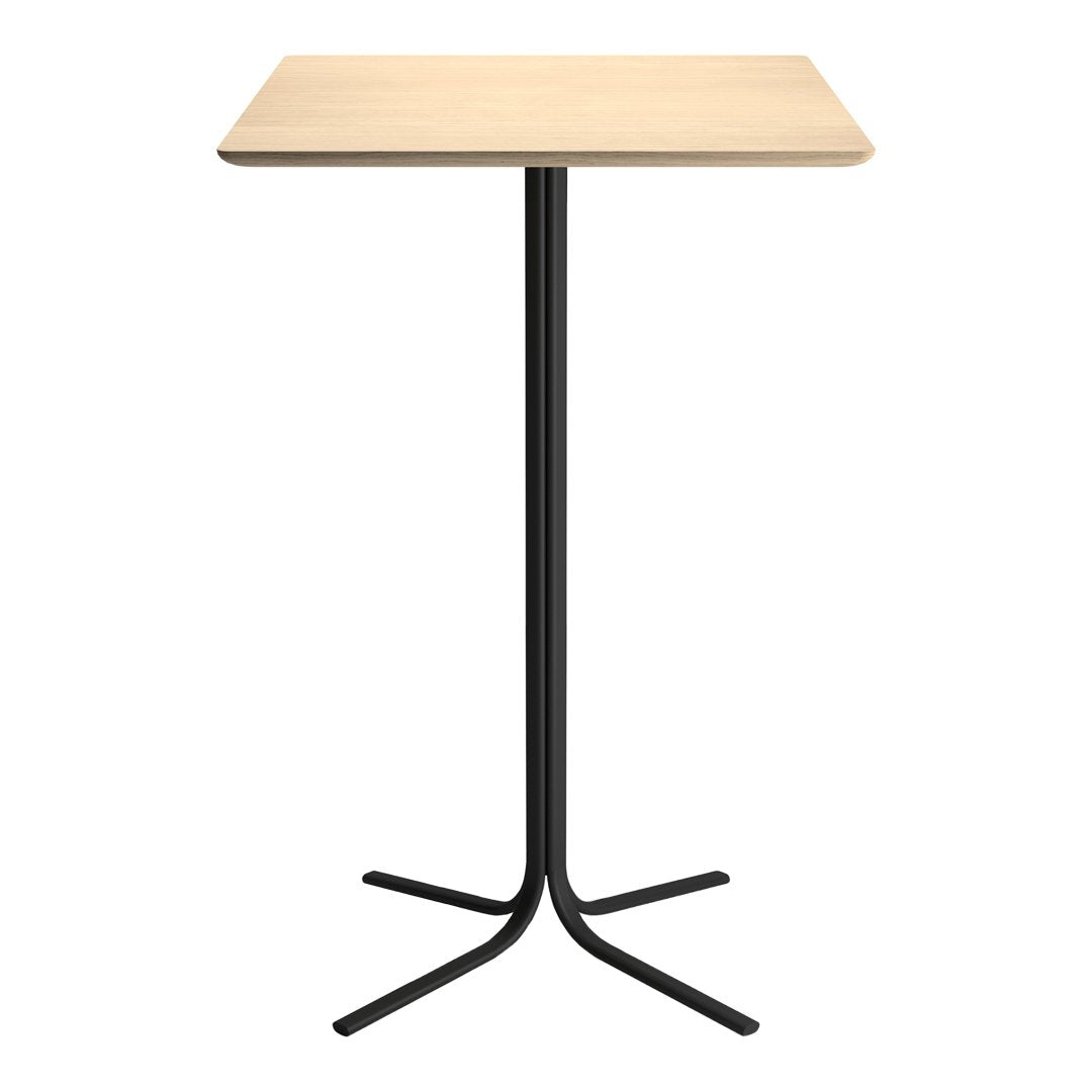 Light wooden tabletop with a smooth finish, supported by a sleek black metal base; minimalist design.