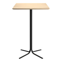 Light wooden tabletop with a smooth finish, supported by a sleek black metal base; minimalist design.