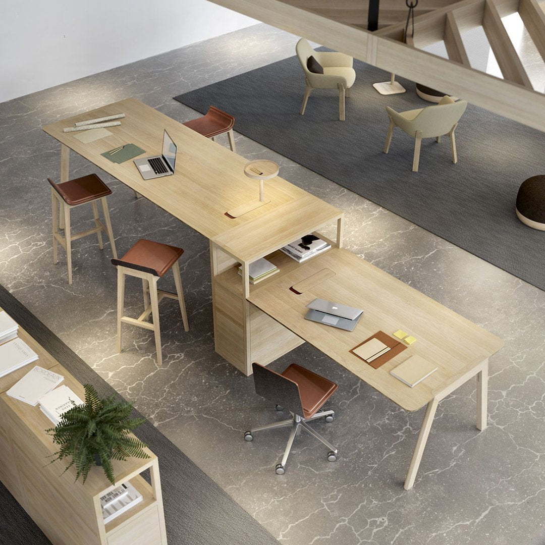 Modern light wood desk with sleek lines, contrasting brown leather stools, and a neutral gray floor creating a minimalist workspace.