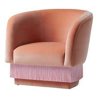 Soft peach velvet armchair with a textured pink fringe base, combining elegance and a modern touch.