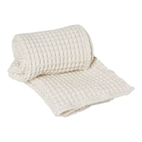 Light ivory textured blanket with a classic woven pattern, adding warmth and elegance to any space.