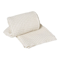 Woven cream-colored fabric roll with a textured, grid-like pattern, perfect for home decor or crafting projects.