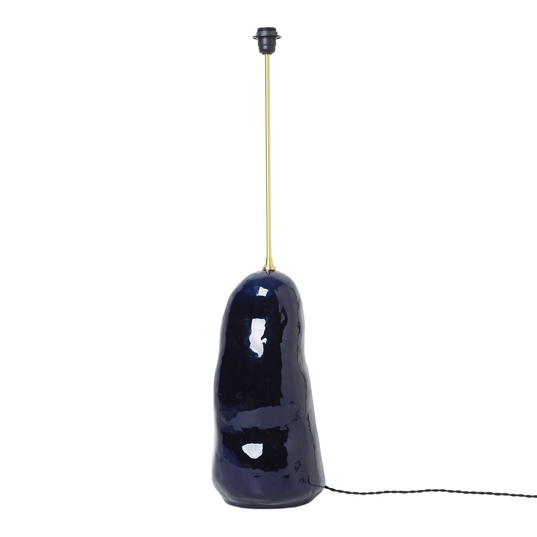 Navy blue ceramic lamp with a glossy finish and gold accent on the socket. Smooth, organic shape.