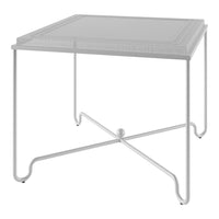 White square side table with a minimalist design and a sleek, cross-legged metal base. Elegant and contemporary style.