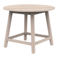 Round light wood table with a smooth surface and natural grain pattern, featuring minimalistic design and neutral tones.