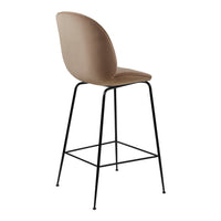 Tan upholstered bar stool with a smooth, rounded back and sleek black metal legs. Perfect for modern decor.