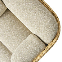Beige textured fabric cushion with a soft, woven pattern, surrounded by a natural wicker frame.