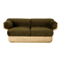 Olive green plush upholstery with natural woven rattan base and curved armrests, offering a cozy, stylish design.