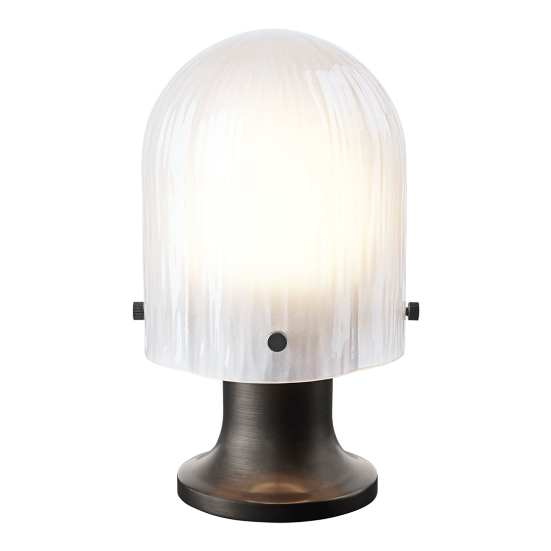 White ribbed glass lampshade on a sleek black base, creating a modern and elegant design. Ideal for chic interiors.