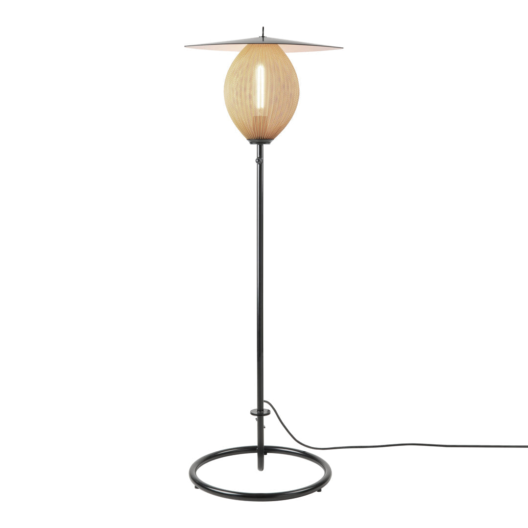 Natural rattan and black metal floor lamp with an oval shade and minimalist design. Perfect for modern decor.