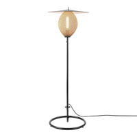 Natural rattan and black metal floor lamp with an oval shade and minimalist design. Perfect for modern decor.