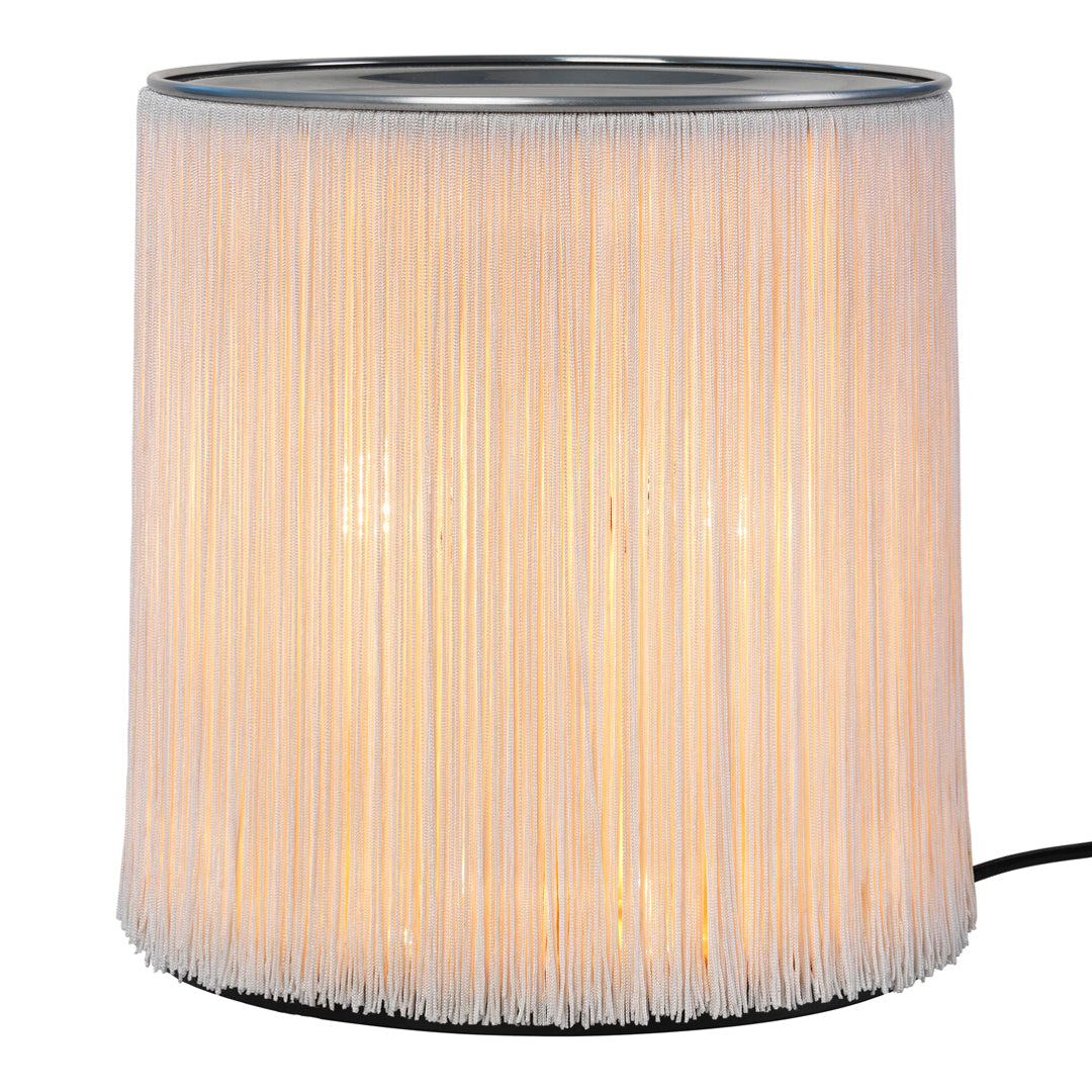 Translucent white fringe lamp with a soft glow, featuring a sleek silver top and minimalist design. Perfect for modern decor.