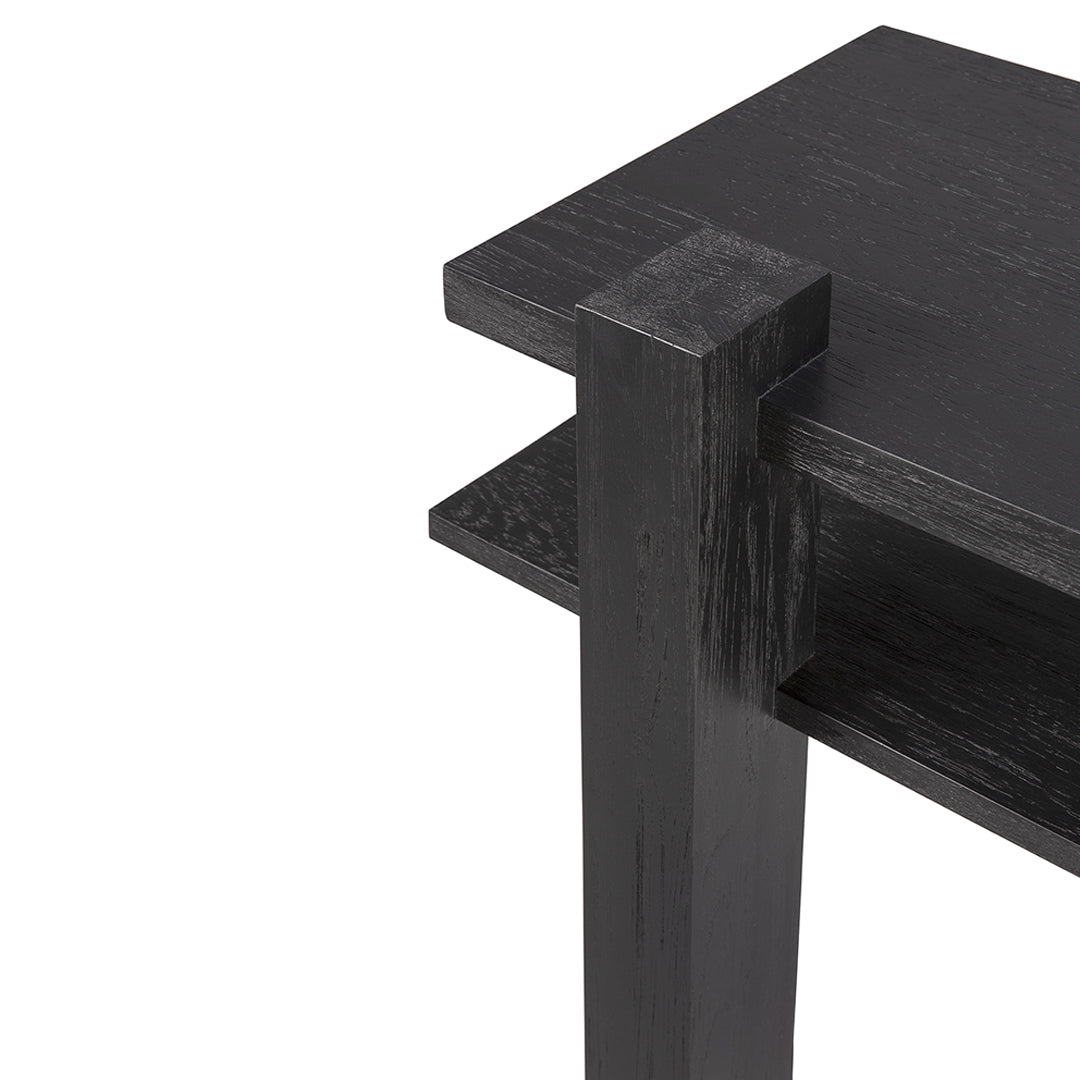 Black wooden table corner with smooth finish and simple modern design. Clean lines and minimalistic aesthetic.