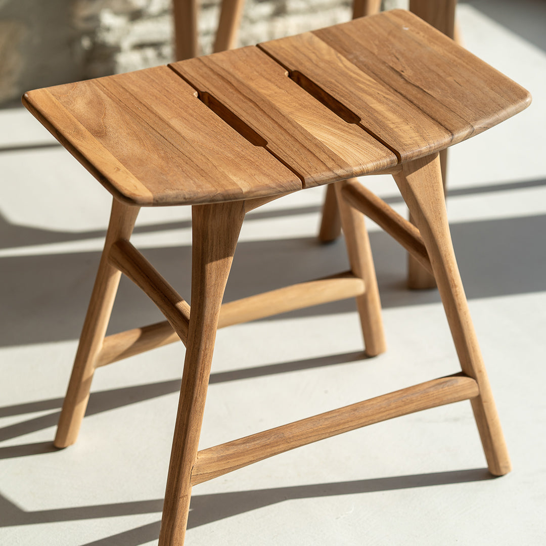 Natural wood stool with a light brown finish and distinct grain patterns, showcasing minimalist design.