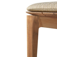 Natural wood tones with a textured beige cushion, showcasing a minimalist design and subtle patterns.