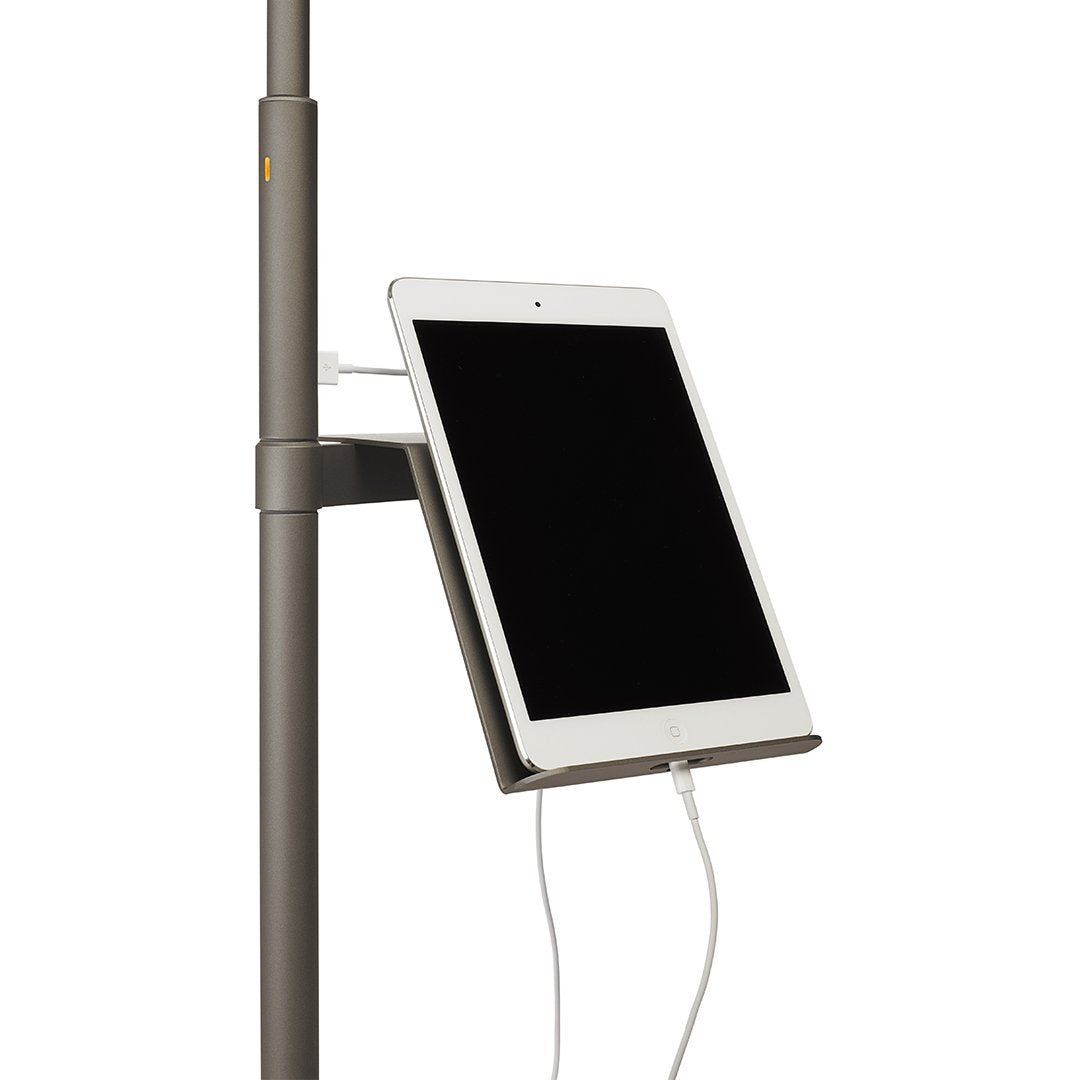 "Gray tablet holder with charging cable, sleek design, minimalistic style, ideal for modern spaces."