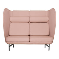 Light pink, smooth upholstery with a modern, minimalist design and bold curved backrest pattern.