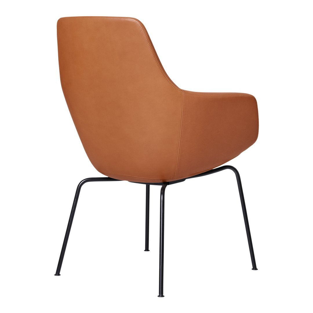 Brown faux leather chair with a sleek design and minimalist black metal legs, perfect for modern decor.