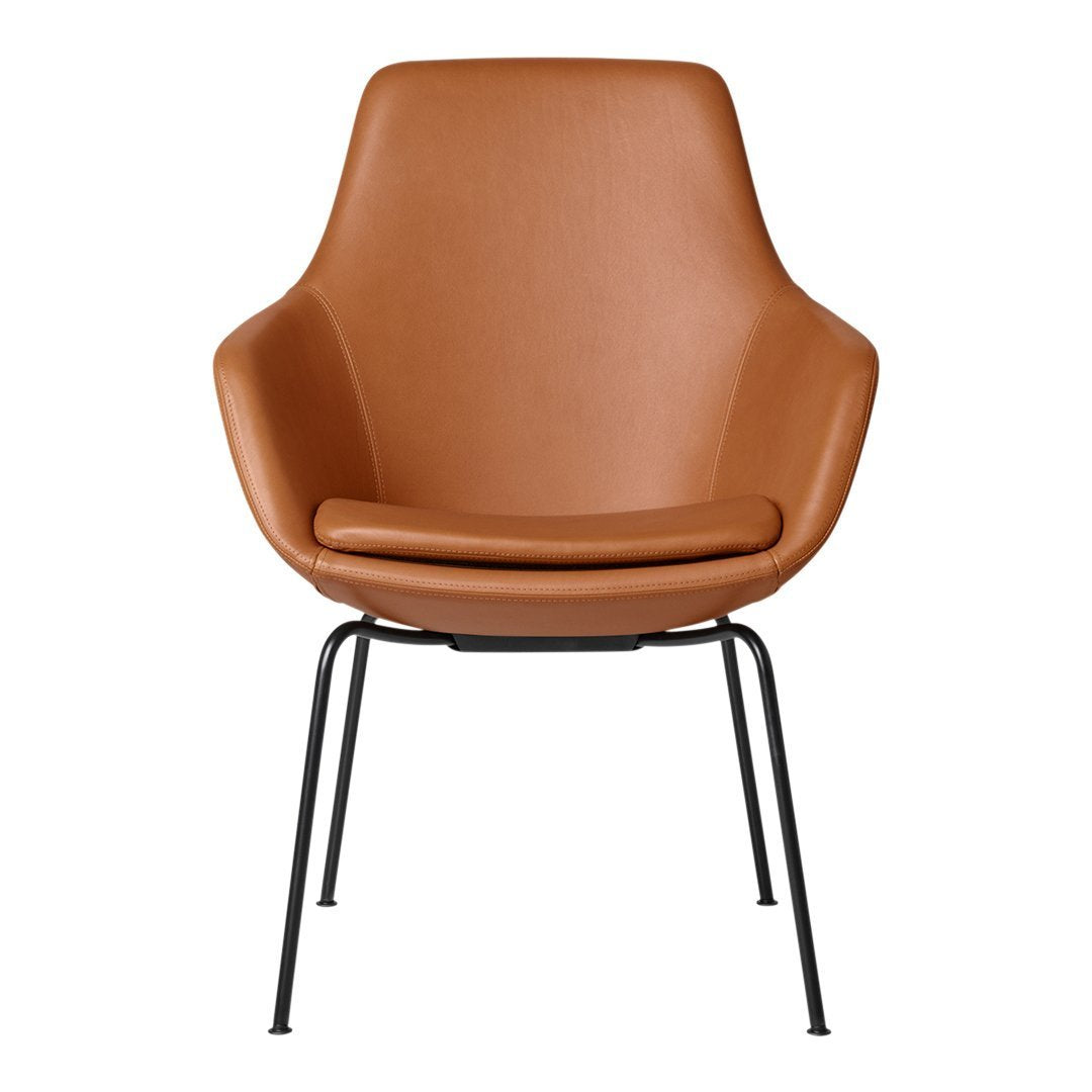 Brown leather armchair with a smooth, sleek finish and black metal legs for a modern, minimalist look.
