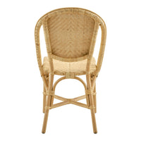 Natural rattan chair with a woven pattern, featuring warm beige tones and curved back design. Perfect for cozy spaces.