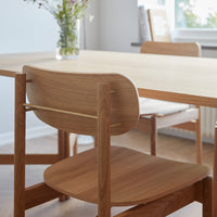 Light wood dining table with simple design, featuring a natural finish and matching wooden chairs. Bright, minimalist aesthetic.