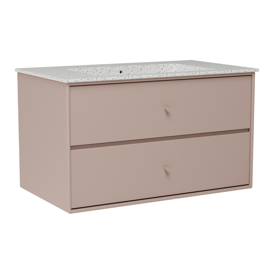 Soft pink dresser with a speckled white countertop and smooth, minimalist drawer fronts. Perfect for modern decor.