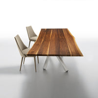 Rustic brown wood tabletop with striking grain patterns, paired with minimalist beige chairs on a sleek gray surface.