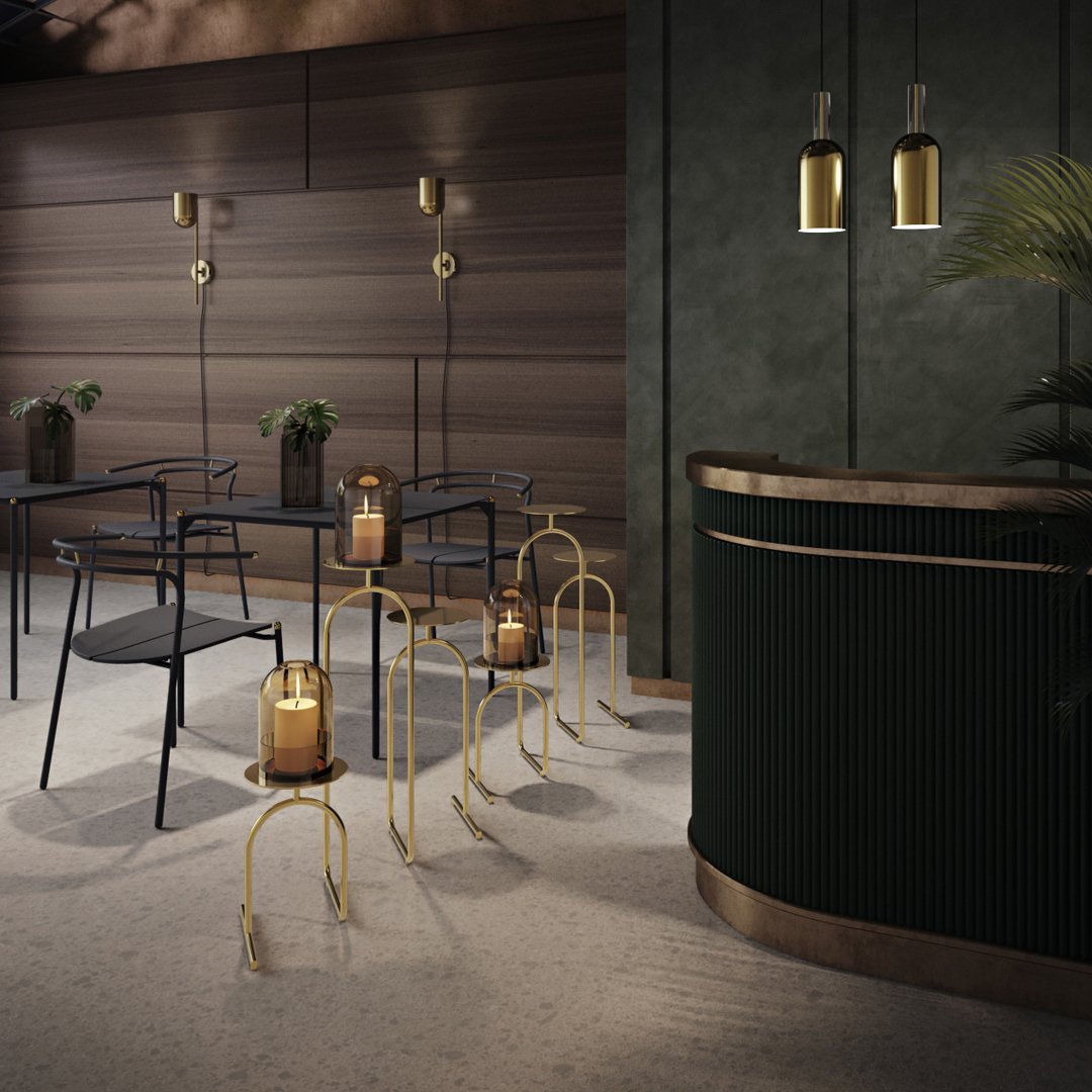 Stylish dark green and gold decor with modern black chairs and soft wood accents, creating a chic ambiance.