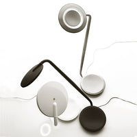 Modern desk lamps in sleek black and white colors with smooth, minimalistic patterns and circular accents.
