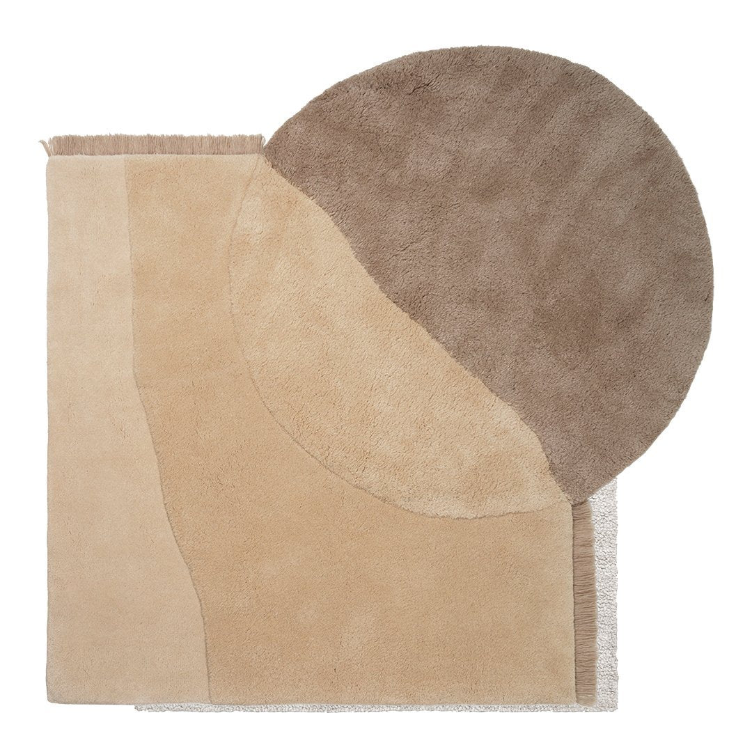 Beige rug featuring abstract shapes with a circular brown pattern and tan accents for modern decor.