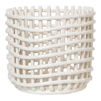 White woven basket with a unique crisscross pattern, perfect for modern decor and organization.