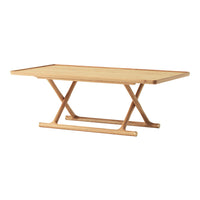 Light brown wooden coffee table with a smooth rectangular top and a minimalist crossed-leg design.