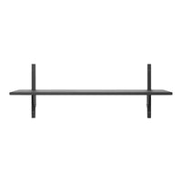 Minimalist black wall shelf with a sleek design, featuring a smooth surface and simple geometric lines.