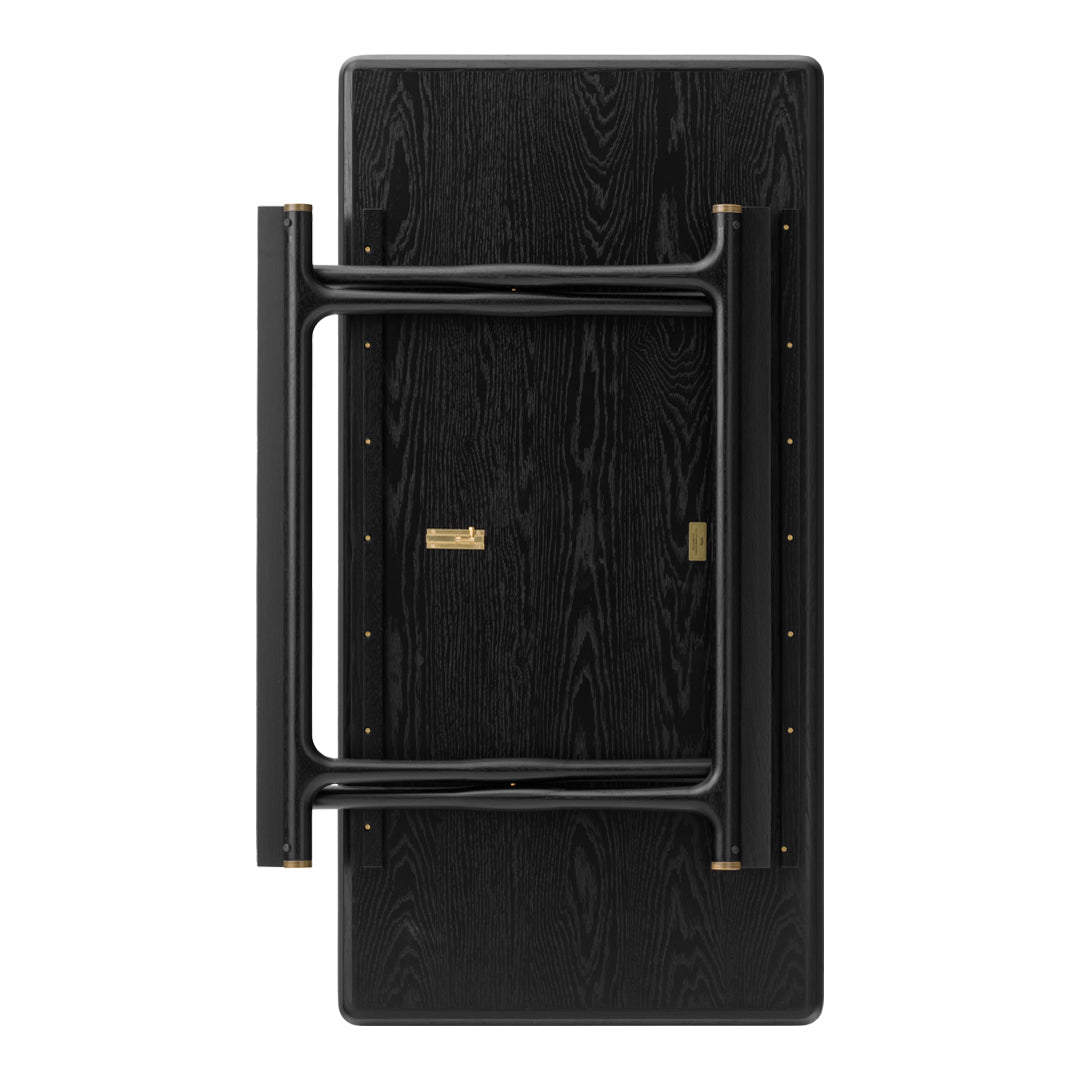 Black folding table with a textured wood finish and sleek black metal legs, accented by gold hardware details.