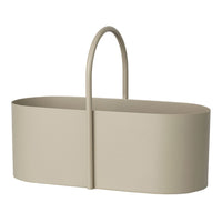 Light beige oval basket with a smooth, minimalist design and a curved handle, ideal for stylish storage solutions.
